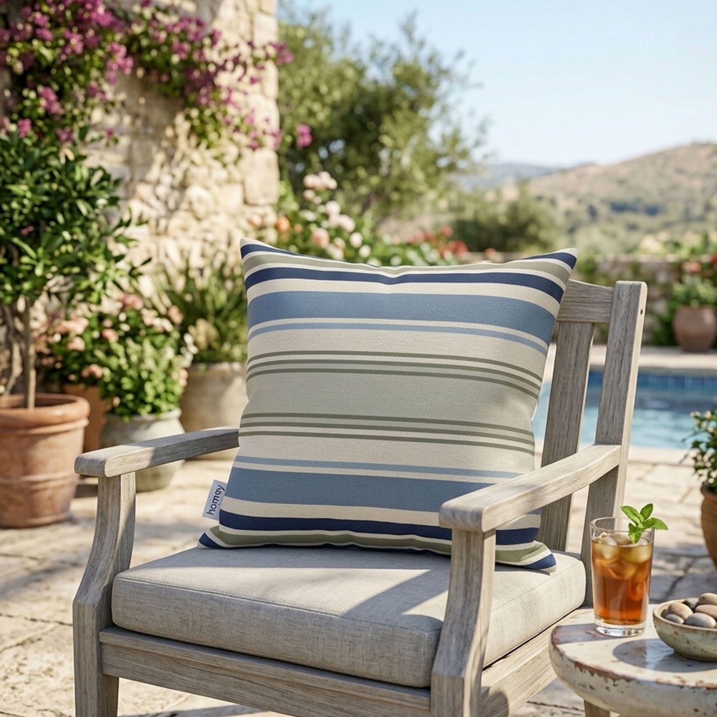 Chair with a striped pillow in an outdoor setting with plants and a pool.