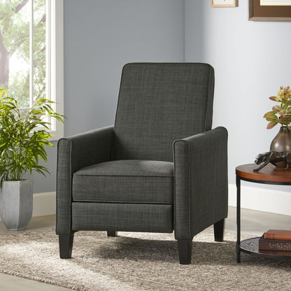 Gray armchair in a living room setting with a side table and plant.