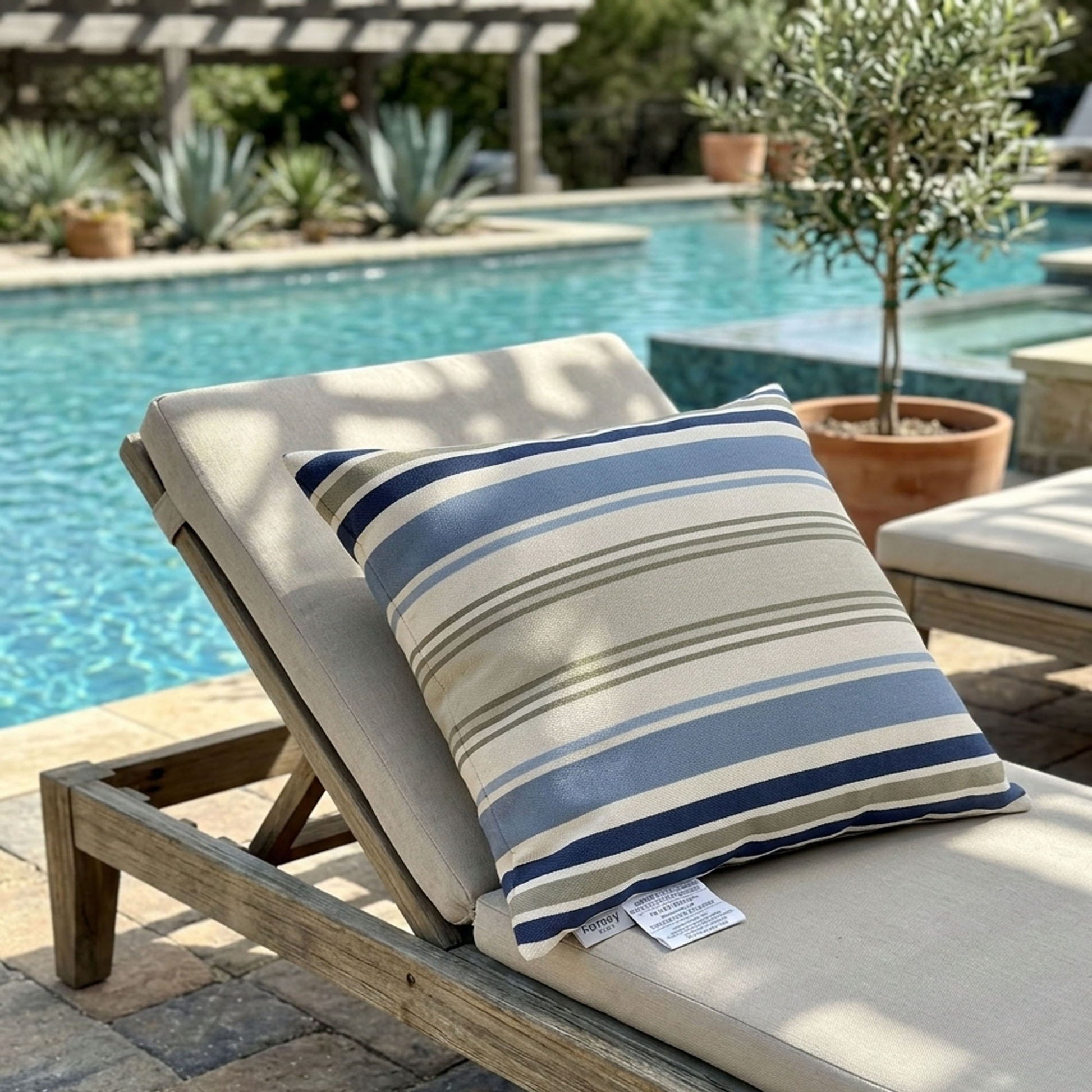 Chair with a striped pillow by a poolside