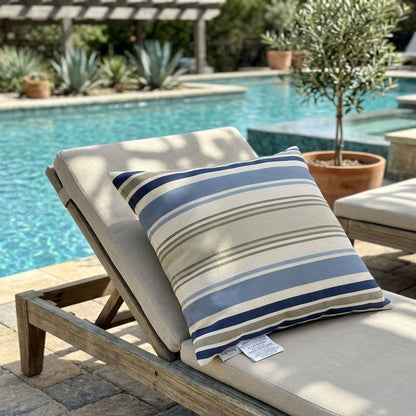 Chair with a striped pillow by a poolside